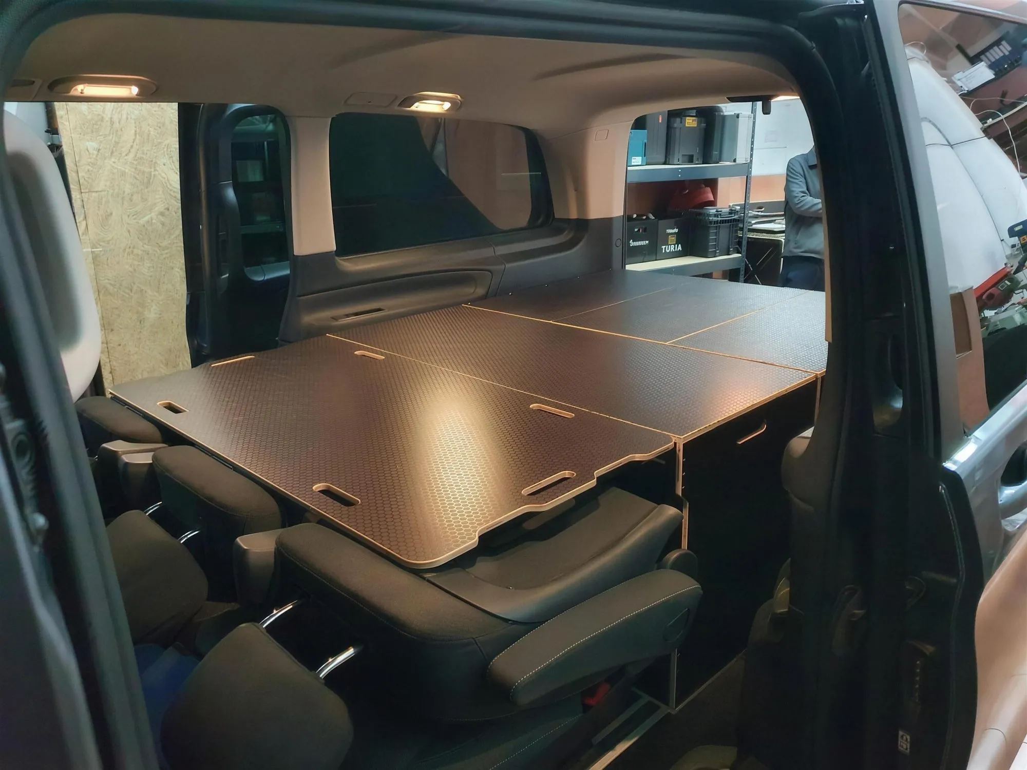 The Alhóndiga Camper modular kit fitted inside a van, in the workshop